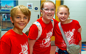  three students in red shirts