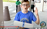  student talking with sign
