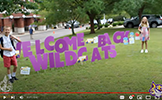  students in front of welcome back wildcats sign