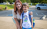  mom and son in front of WSES parking lot
