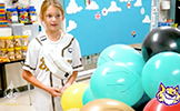  girl with a pile of balloons