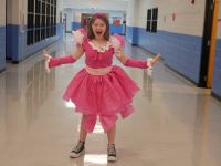  Student in pink dress created from recycled materials