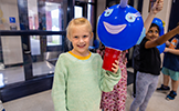  girl with blue decorated balloon