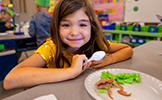  girl with plate of green eggs and ham