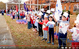  students waving American flags