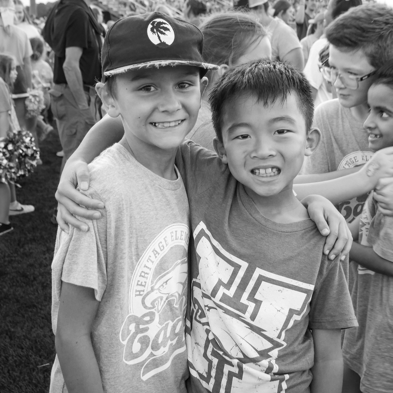 two boys with arms around each other