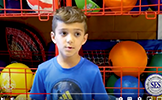 boy in front of sports equipment 