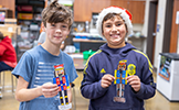  two boys with colored paper nutcrackers
