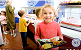  girl with lunch tray in cafeteria