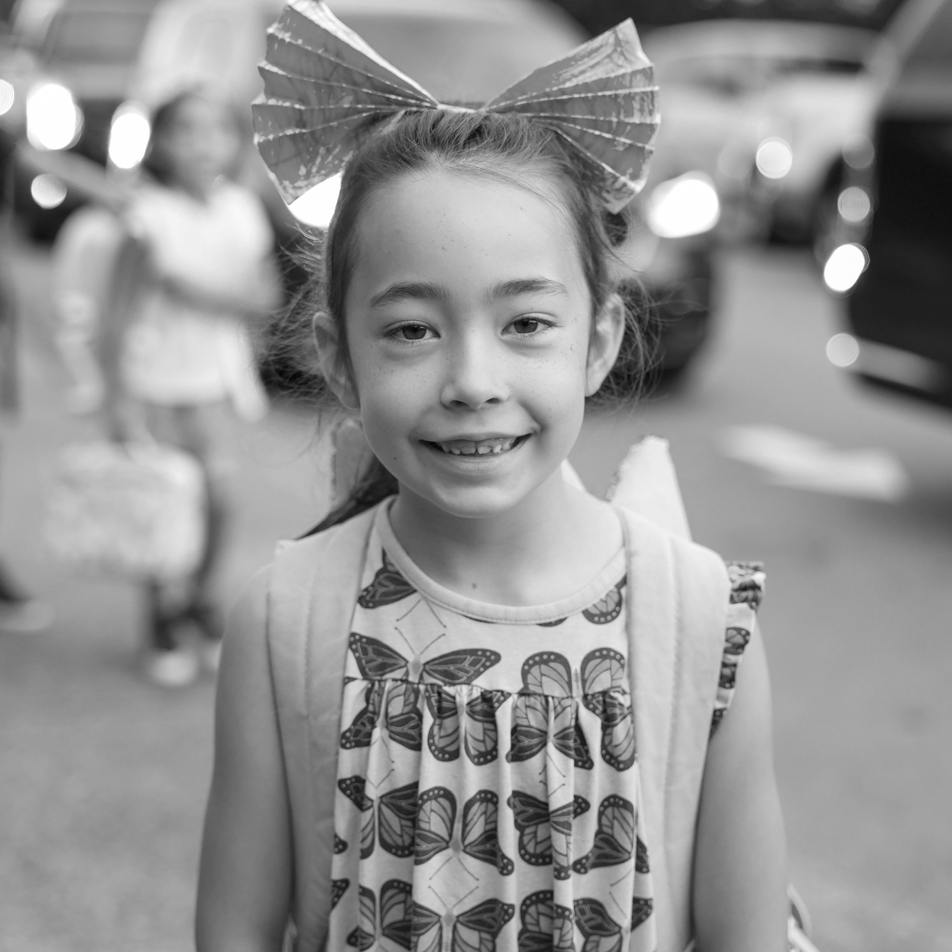girl student smiling with large bow in hair