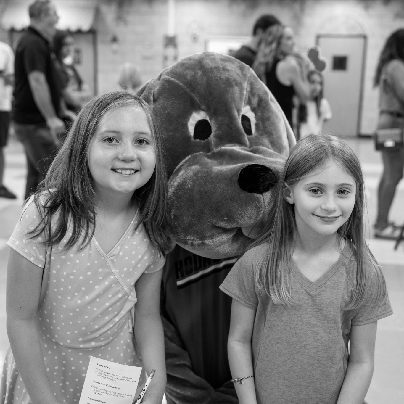 two girls smiling with mascot