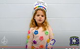  girl in hat and colorful sweater