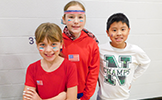  three students smiling in the gym