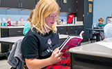  girl reading at desk