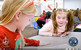  girl with wide eyes looking at robot