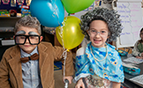  two students dressed in gray wigs