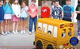  students watching remote control bus
