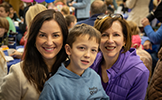  boy with mom and grandma smiling