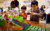  students at a table with blocks