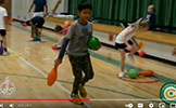  student holding two bowling pins