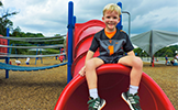 a boy sitting on the playground