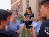  a group of students discuss in a group outside
