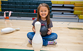 girl in gym with bowling pin  