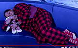  principal davis sleeping on the couch in plaid pajamas
