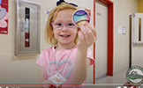  girl holding up a tie dye sticker