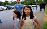  a girl walking to school in a yellow dress