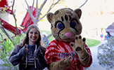  girl and cheetah mascot giving thumbs up