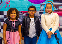  three students in 50's outfits