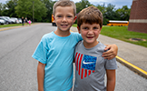  two boys with arms around each other