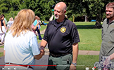  assistant principal shaking hands with sherriff's deputy and helicopter pilot
