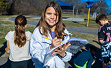  girl writing in notebook smiling