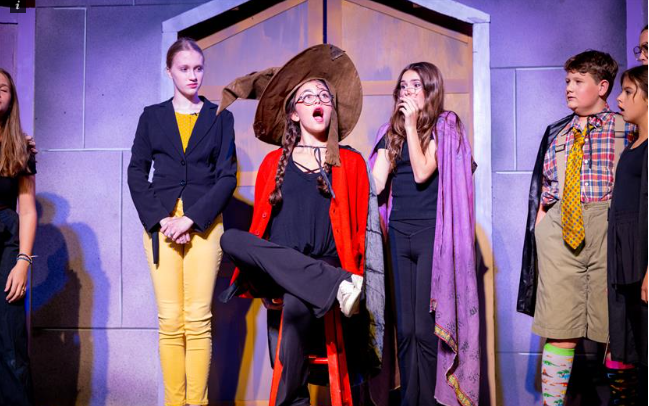  Students performing a scene in the play.