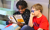 two students reading a book