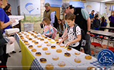  student at a table filled with donuts