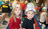  two students in solar eclipse paper hats