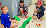  students smiling with STEM activity