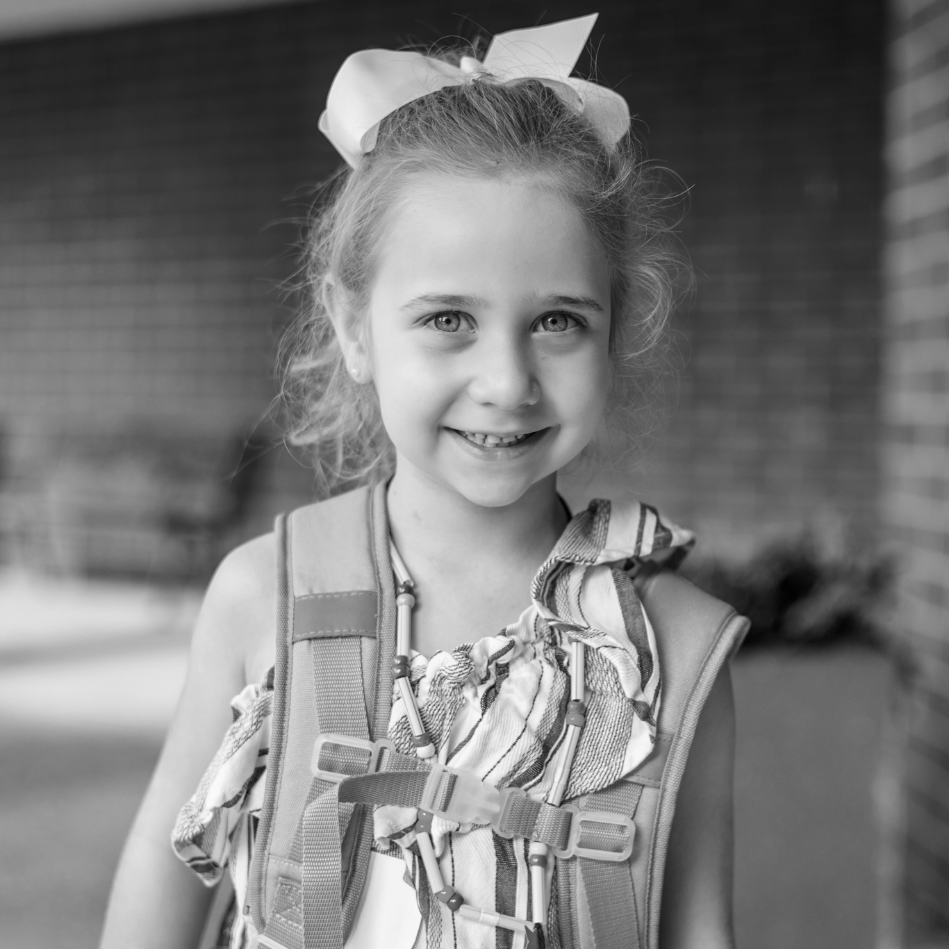 a girl smiling with a backpack