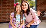 mom and girl student smiling