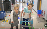  two girls dressed as 100 year old ladies with a walker