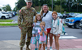  family in front of SSES parking lot