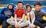  four boys in helmets smiling