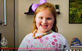  girl smiling wearing necklace
