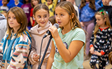  girl singing into microphone