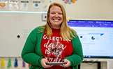  teacher holding a trophy