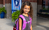 girl with purple backpack