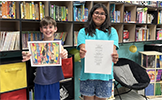  two students holding art
